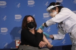 U.S. Vice President Kamala Harris receives her second dose of the Moderna coronavirus disease (COVID-19) vaccine from nurse practitioner Judy Lai Yee Chan at the National Institutes of Health in…