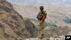 FILE - A Pakistan army soldier stands guard in the Pakistani tribal area of Khyber near the Torkham border post between Pakistan and Afghanistan, June 15, 2016.