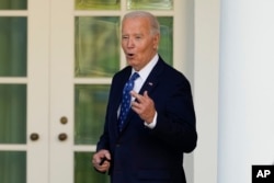 U.S. President Joe Biden, with his fingers crossed, speaks to reporters after being asked a question about a Gaza ceasefire, at the White House in Washington on Nov. 26, 2024.