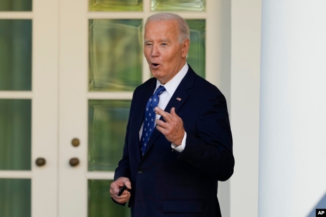 U.S. President Joe Biden, with his fingers crossed, speaks to reporters after being asked a question about a Gaza ceasefire, at the White House in Washington on Nov. 26, 2024.