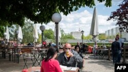 A guest enjoys his beer at a beer garden near the Chancellery in Berlin, Germany, May 21, 2021, as parts of the country began easing COVID-19 restrictions. 