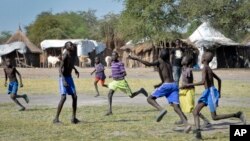 FILE - In this photo taken Dec. 8, 2017, boys play a game of soccer in Jiech, Ayod County, South Sudan.