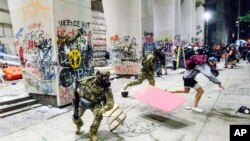 Federal officers disperse Black Lives Matter demonstrators at the Mark O. Hatfield United States Courthouse, July 22, 2020, in Portland, Oregon.