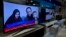 A Pakistani channel broadcasts a report about western couple, seen at a local electronic shop in Islamabad, Pakistan, Thursday, Oct. 12, 2017.