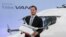 FILE - Frieder Soenning, employee of the Daimler AG, presents the Matternet Drone-equipped delivery van Mercedes Vision Van at the International Transport Forum 2017 in Leipzig, Germany, May 31, 2017. 