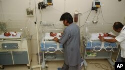 FILE - In this file photo taken Oct. 4, 2006, Pakistani hospital staff members attend newly born babies in Karachi, Pakistan. (AP Photo/Shakil Adil, File)