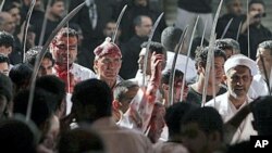 Bahraini men participates in a mourning procession with other Shiite men and boys, cutting their heads with the tips of swords to draw blood as they mark Ashura, the anniversary of the 7th century death of Imam Hussein, grandson of Islam's founding prophe