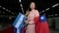 A Taiwanese citizen living in Managua holds Nicaragua's flag and Taiwan's flag as she waits for arrival of Tawain's President Tsai Ing-wen at the textile industrial park in Managua, Nicaragua Jan. 10, 2017. 