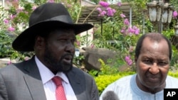 FILE - South Sudan President Salva Kiir, left, along with former president of Mali, Alpha Oumar Konaré, the AU High Representative for South Sudan, answer questions at the presidential palace in Juba, South Sudan, July 14, 2016. 