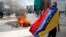 FILE - Protesters clash with riot police during a rally to demand a referendum to remove Venezuela's President Nicolas Maduro in Caracas, Venezuela.