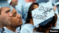 FILE - A graduate from Columbia University's School of Engineering sleeps during the university's commencement ceremony in New York, May 16, 2012.