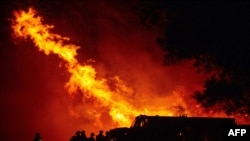 Butte county firefighters watch as flames tower over their truck at the Bear fire in Oroville, California on September 9, 2020.