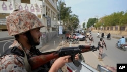 Paramilitary soldiers stand guard on the side of a road for security, ahead of Feb. 8 general elections, in Karachi, Pakistan, Feb. 7, 2024.