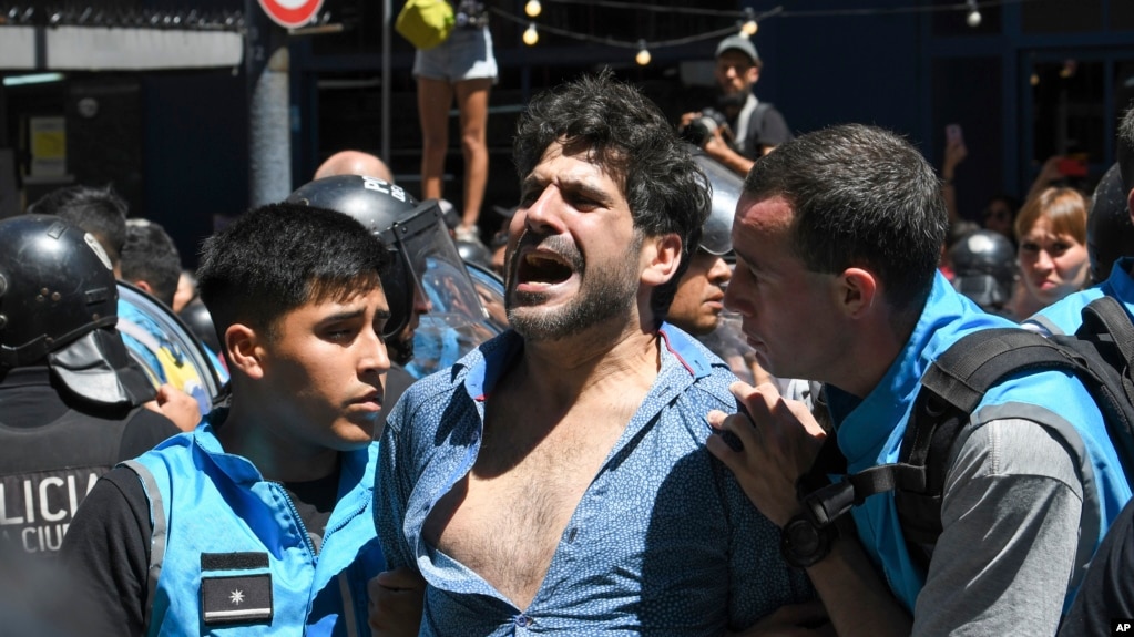 Police detain a protester during an anti-government demonstration against the economic reforms of President Javier Milei in Buenos Aires, Argentina, Dec. 27, 2023.