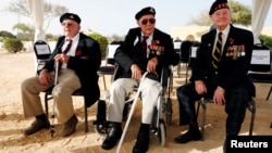 British World War II veterans Alex Munro, 96, Joe Peel, 98, and Bill Blackburn,98, attend a ceremony for the anniversary of the Battle of El Alamein, at El Alamein war cemetery in Egypt, Oct. 20, 2018. 