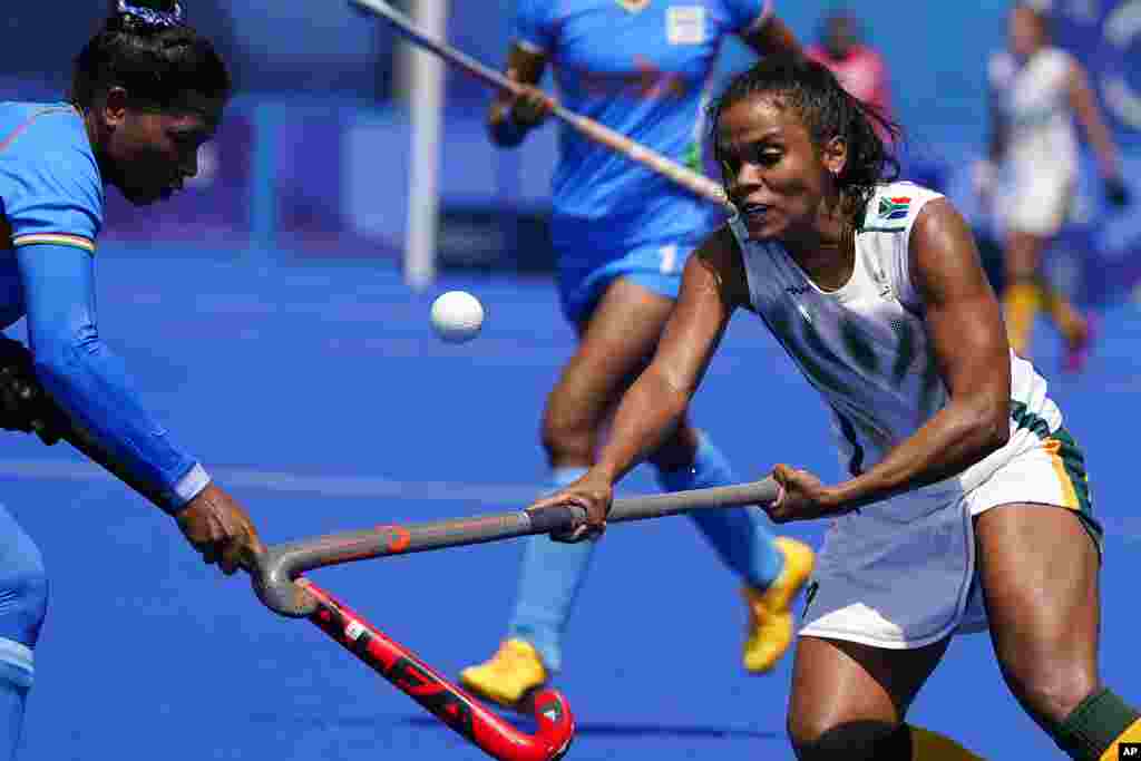 South Africa&#39;s Toni Marks, right, and India defender Deep Grace Ekka (3) battle for the ball during a women&#39;s field hockey match at the 2020 Summer Olympics, Saturday, July 31, 2021, in Tokyo, Japan. (AP Photo/John Locher)