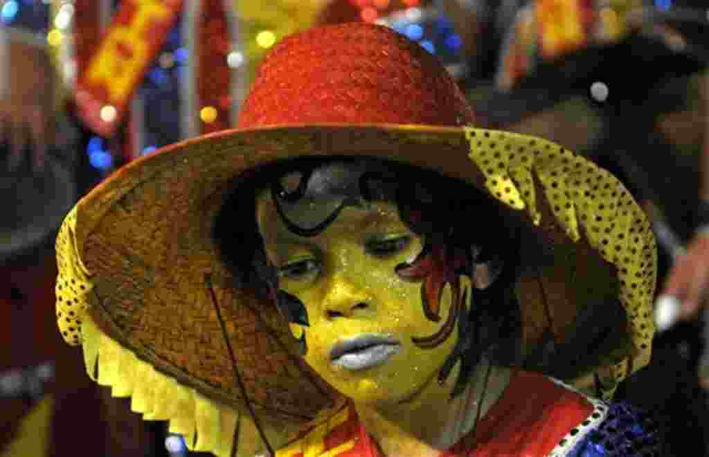 A drummer, dressed in traditional clothes, performs at the Las Llamadas carnival parade in Montevideo, Uruguay,Thursday, Feb. 3, 2011. (AP Photo/Matilde Campodonico)