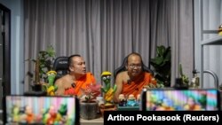 Biksu Buddha Phra Maha Sompong Talaputto dan Phra Maha Paiwan Warawanno menjadi pembawa acara obrolan selama siaran langsung Facebook, di sebuah kuil di Bangkok, Thailand, 17 September 2021. (Foto: REUTERS/Arthon Pookasook)