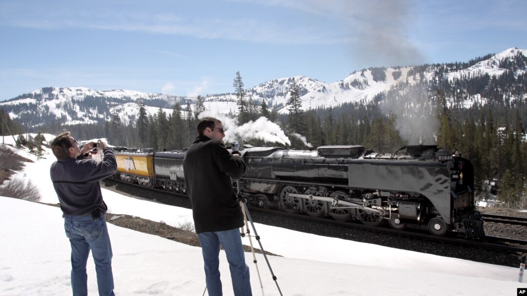 FILE - A Union Pacific Railroad's steam locomotive, the rail lines' last operational steam engine, passes through the Sierra Nevada mountains at Norden, California. 