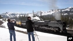 FILE - A Union Pacific Railroad's steam locomotive, the rail lines' last operational steam engine, passes through the Sierra Nevada mountains at Norden, California. 