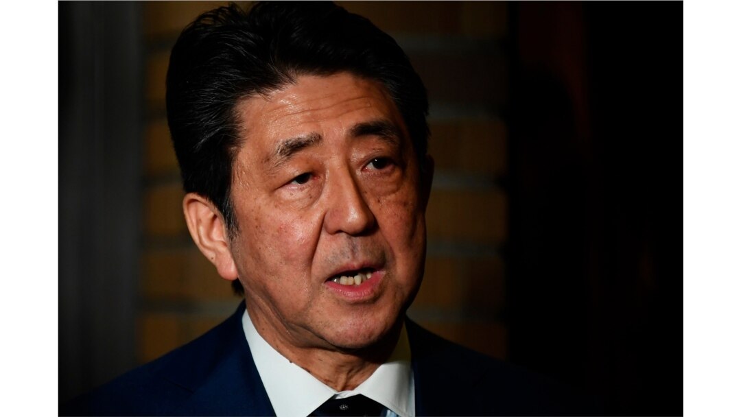 Japan's Prime Minister Shinzo Abe talks to journalists in Tokyo, March 24, 2020.
