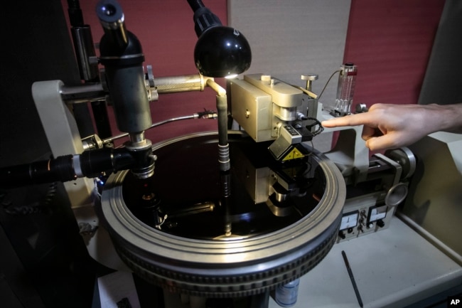 Sound operator William Carvalho begins cutting a record on an acetate surface that is part of the first stage of vinyl production at the Polysom factory in Belford Roxo, Brazil, Tuesday, April 16, 2024. (AP Photo/Bruna Prado)