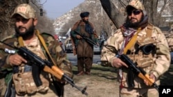 FILE - Taliban fighters stand guard in Kabul, Dec. 26, 2022. 