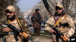 FILE - Taliban fighters stand guard in Kabul, Dec. 26, 2022. 