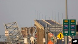 FILE— Parts of the Francis Scott Key Bridge remain after a container ship collided with a support Tuesday, March 26, 2024 in Baltimore.