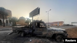 FILE - A burned vehicle is seen in Khartoum, Sudan April 26, 2023. 