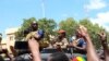 Burkina Faso's new military leader Ibrahim Traore is escorted by soldiers while he stands in an armored vehicle in Ouagadougou, Burkina Faso October 2, 2022.