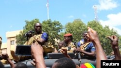 Burkina Faso's new military leader Ibrahim Traore is escorted by soldiers while he stands in an armored vehicle in Ouagadougou, Burkina Faso October 2, 2022.