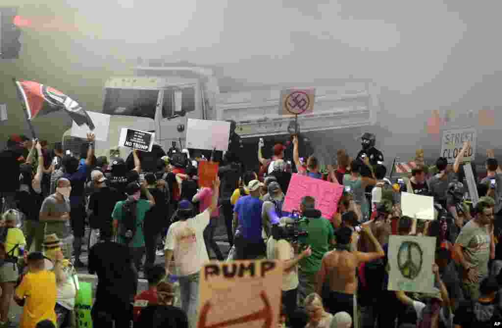 Protesters yell after Phoenix police used tear gas outside the Phoenix Convention Center, Aug. 22, 2017, in Phoenix. Protests were held against President Donald Trump as he hosted a rally inside the convention center.
