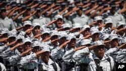 National Guard soldiers salute as the new force is presented during a ceremony at a military field in Mexico City, June 30, 2019.. 