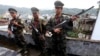 FILE - In this Oct. 29, 2013, file photo, soldiers of the Kachin Independence Army stand on guard in Laiza, a border town of China and Myanmar, Kachin State, Myanmar. 