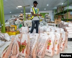 FILE—A volunteer counts stock of food items in the Lagos Food Bank warehouse in Lagos, Nigeria, March 23, 2024.