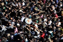 FILE - Mourners carry the body of Palestinian Islamic Jihad field commander Baha Abu Al-Atta during his funeral in Gaza City, Nov. 12, 2019.