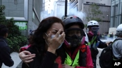 A woman cries as she pleads with the police not to beat a man as police detain protesters calling for electoral reforms and a boycott of the Chinese Communist Party in Hong Kong, Sunday, Jan. 19, 2020. Hong Kong has been wracked by often violent anti…