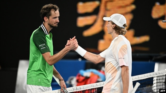 Russia's Daniil Medvedev (L) greets Finland's Emil Ruusuvuori after victory in their men's singles match on day five of the Australian Open tennis tournament in Melbourne early on January 19, 2024.