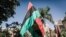 FILE—People hold Biafra flags as they take part in a protest in Durban, South Africa, on May 30, 2019 during a Freedom March for Biafra held worldwide to mark the anniversary of the unilateral declaration of independence in 1967 that sparked a 30-month civil war in Nigeria. 