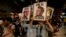 Demonstrators holding posters of Mexico's President Enrique Pena Nieto, right, and Attorney General, Jesus Murillo Karam, left, march in protest for the disappearance of 43 students in the state of Guerrero, in Mexico City, Nov. 5, 2014. 