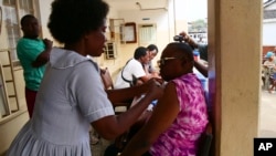 A health worker administers a dose of Ebola vaccine to a man at the Christian Maternity Hospital in Freetown, Sierra Leone, on Dec. 5, 2024.