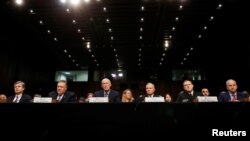 Left to right, Federal Bureau of Investigation (FBI) Director Christopher Wray; Central Intelligence Agency (CIA) Director Mike Pompeo; Director of National Intelligence (DNI) Dan Coats; Defense Intelligence Agency Director Robert Ashley; National Security Agency (NSA) Director Michael Rogers; and National Geospatial Intelligence Agency Director Robert Cardillo testify before a Senate Intelligence Committee hearing on "Worldwide Threats" on Capitol Hill in Washington, Feb. 13, 2018. 