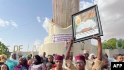 FILE - Supporters of Nigerien President Mohamed Bazoum gather to show their support for him in Niamey on July 26, 2023.