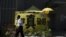 A security guard walks past a tent set up by pro-democracy protesters outside government headquarters in Hong Kong, China, June 16, 2015. 