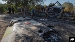 Ukrainian servicemen examine fragments of a Russian military plane that was shot down on the outskirts of Kostyantynivka, a near-front line city in the Donetsk region, Ukraine, Oct. 5, 2024.