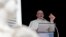 FILE - Pope Francis shows a crucifix during the Angelus noon prayer he delivers from the window of his studio overlooking St. Peter's Square at the Vatican, Sept. 16, 2018. 