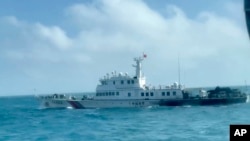 In this screen grab from video released by the Taiwan Coast Guard, a view of a China Coast Guard boat from a Taiwan Coast Guard boat as it passes near the coast of Matsu islands, Taiwan on Oct. 14, 2024. (Taiwan Coast Guard via AP)