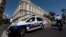 A police car is seen parked outside the Carlton hotel in Cannes, France, July 28, 2013. 