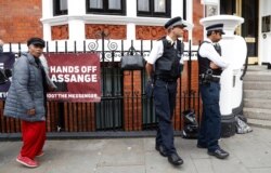 British police guard Ecuadorian Embassy as protesters in support of Wikileaks founder Julian Assange demonstrate in London, May 20, 2019.